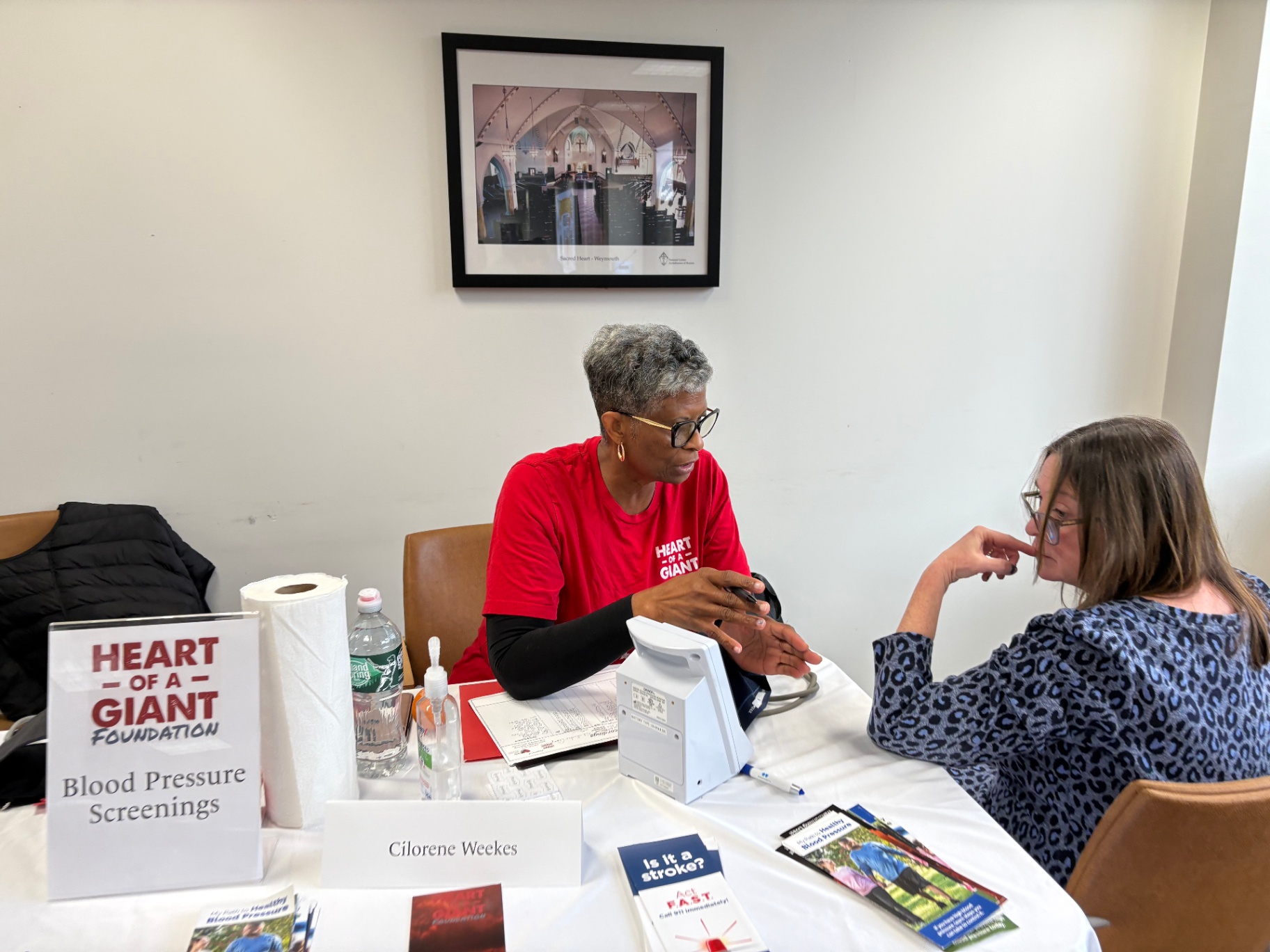 Cilorene Weekes at a Heart of a Giant blood pressure screening table.