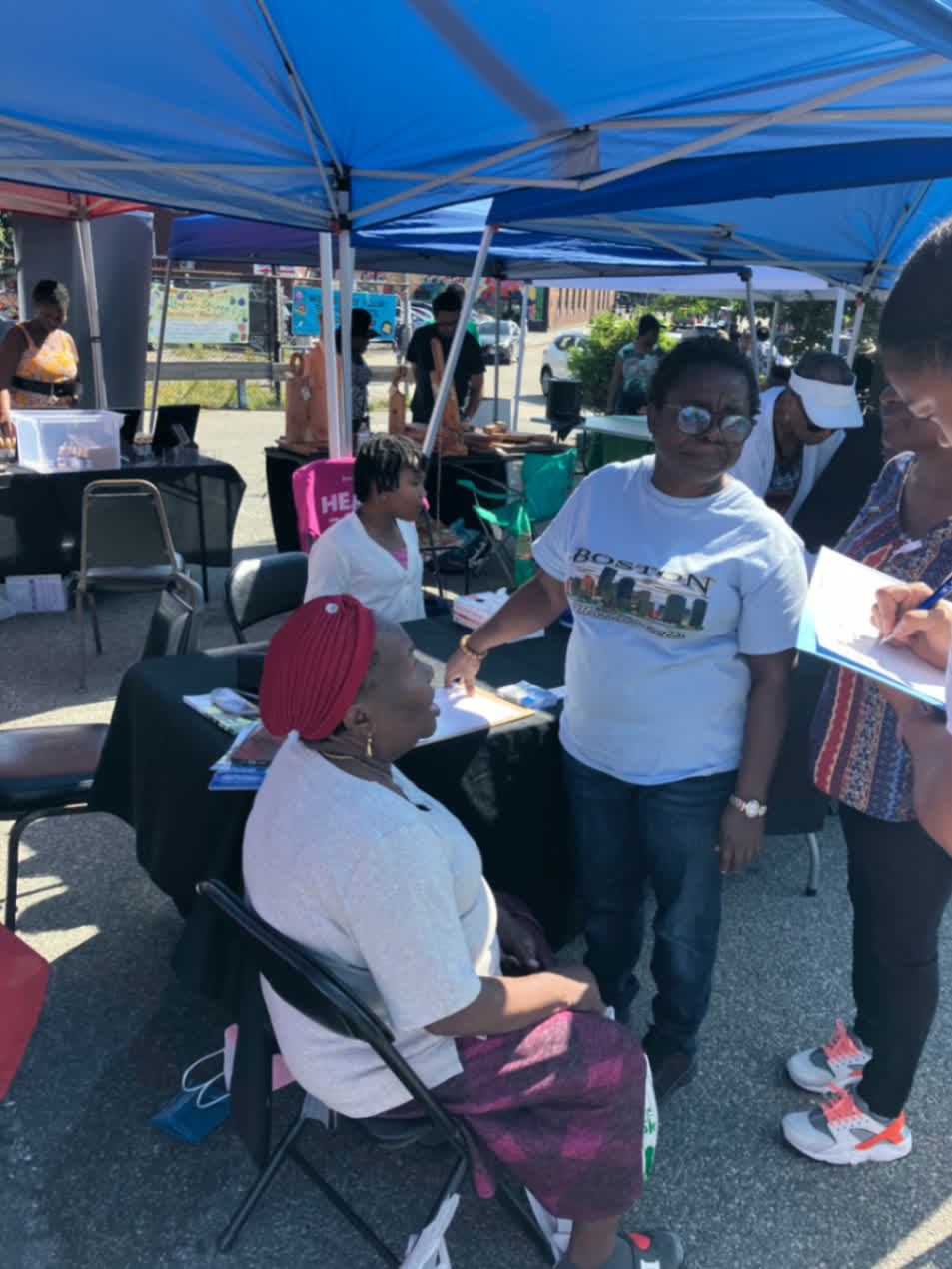 Neighbors gathering and checking in during a Mattapan screening day.