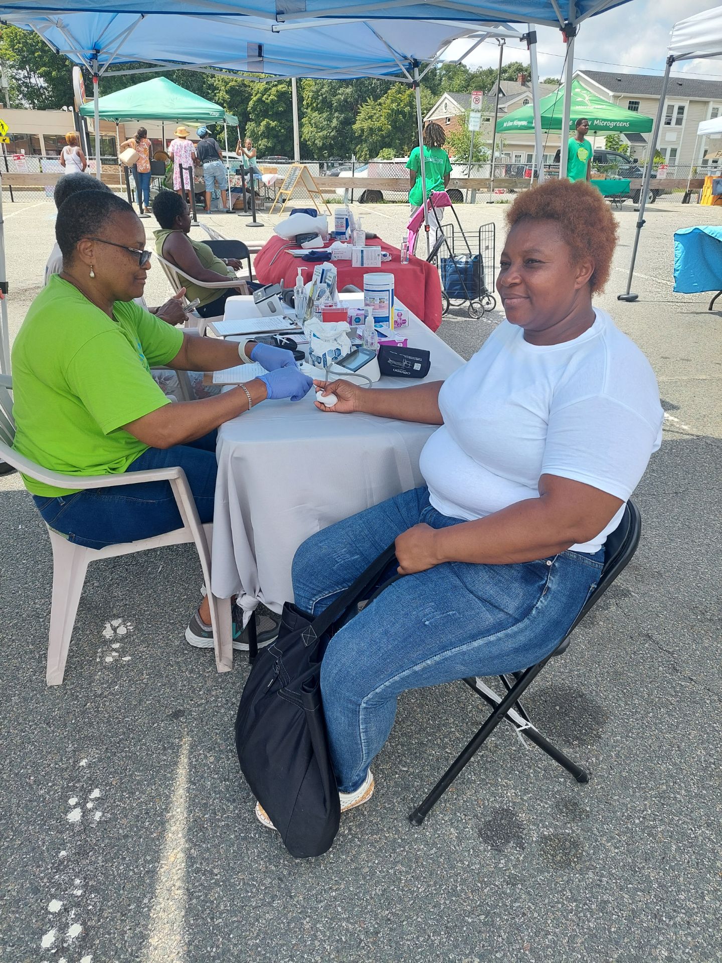 Health coach reviewing a participant’s numbers at a Mattapan screening.